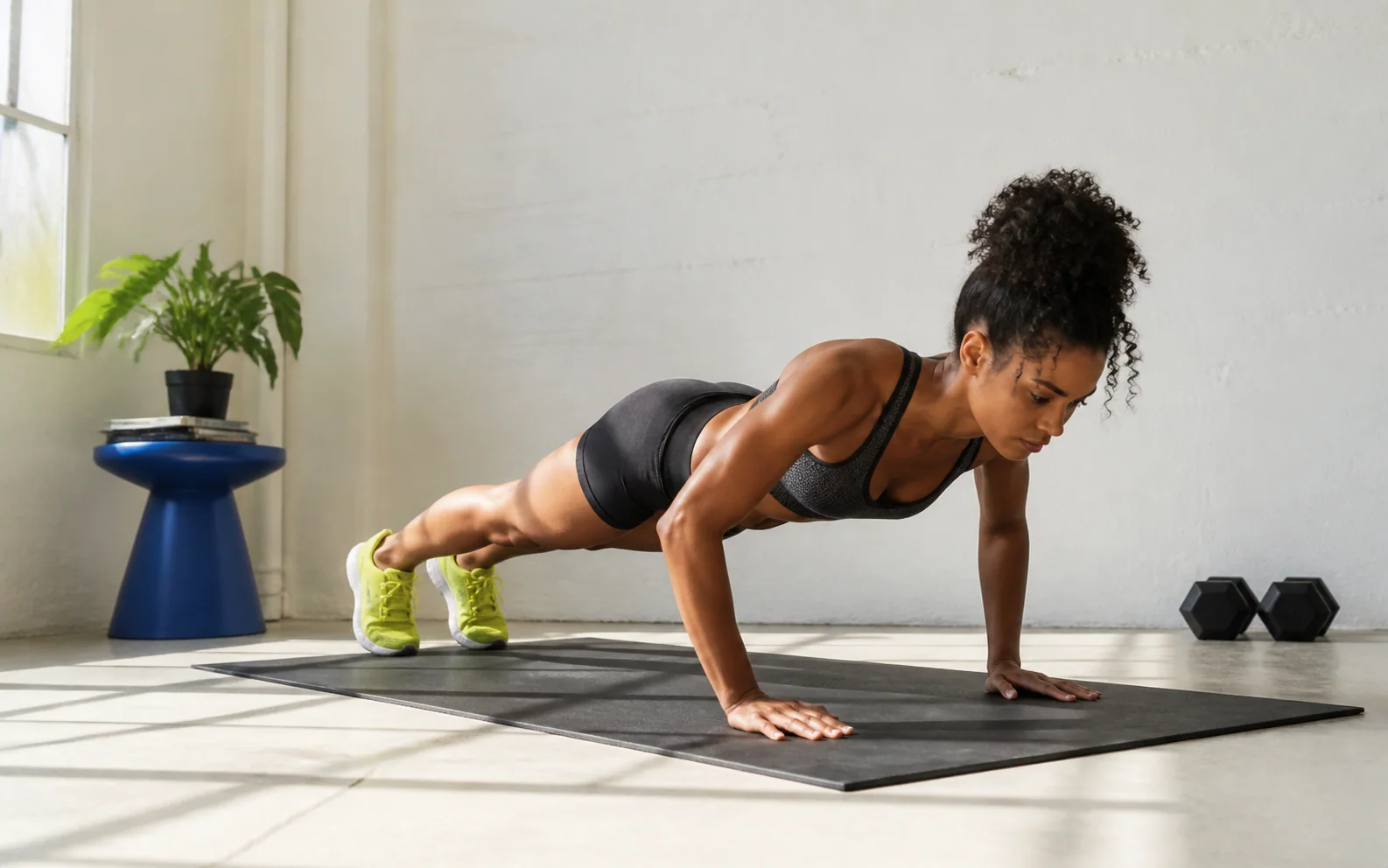 Woman completing a bodyweight push-up on a mat at home